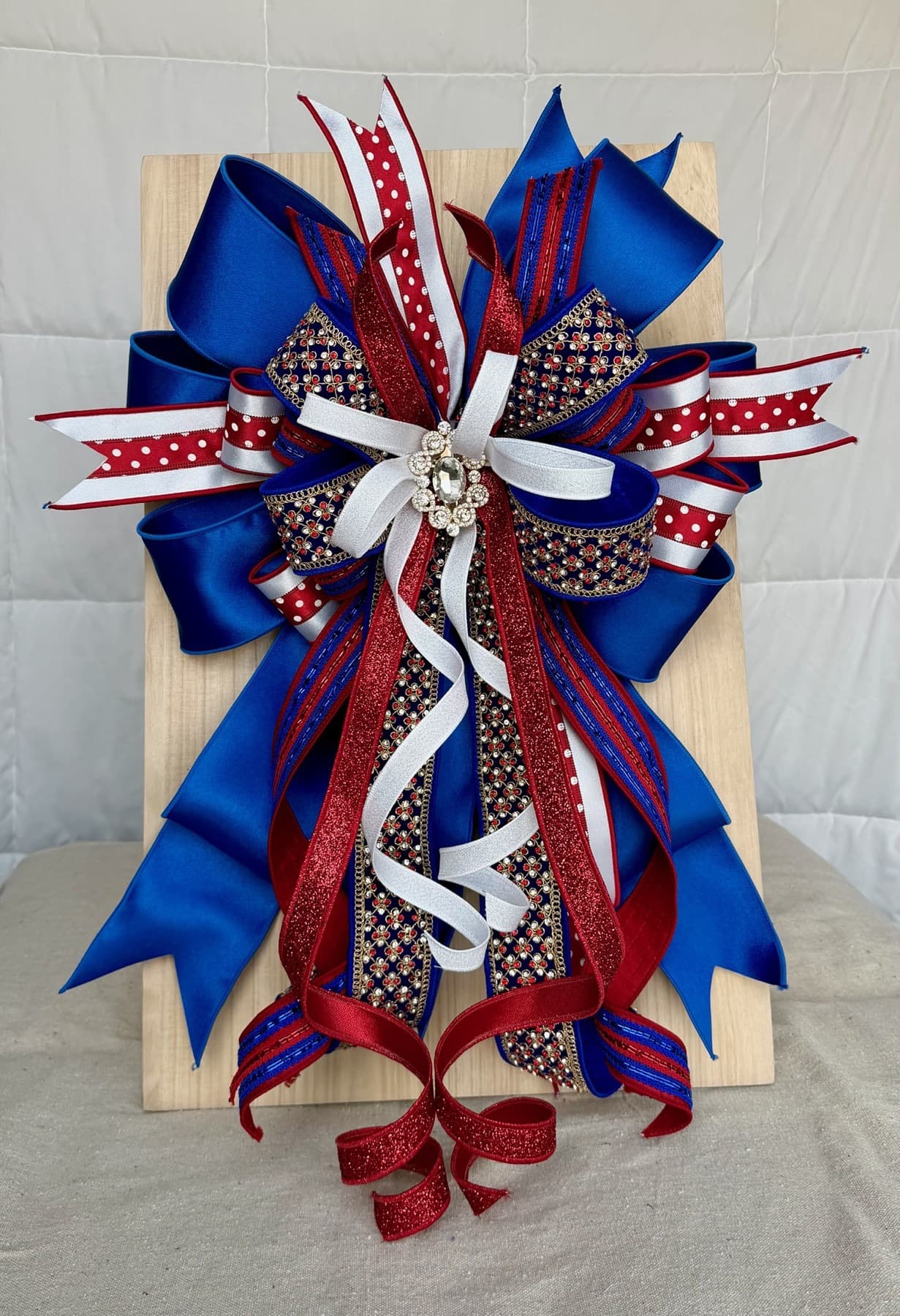 A detailed red, blue, and white ribbon bow shaped for holiday styling.